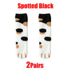A pair of spotted black cat paw print plush socks shown against a white background.