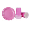 A pink disposable tableware set including a plate and a striped paper cup.