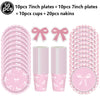 A set of pink disposable party tableware including 10 plates, cups, and napkins with bow designs.