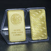 A gold-colored bullion ingot labeled 99.99% pure gold and 1 ounce, packaged in clear plastic.