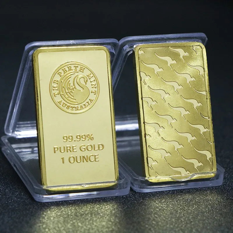 A gold-colored bullion ingot labeled 99.99% pure gold and 1 ounce, packaged in clear plastic.