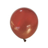 A single matte reddish-orange latex balloon floating against a white background.