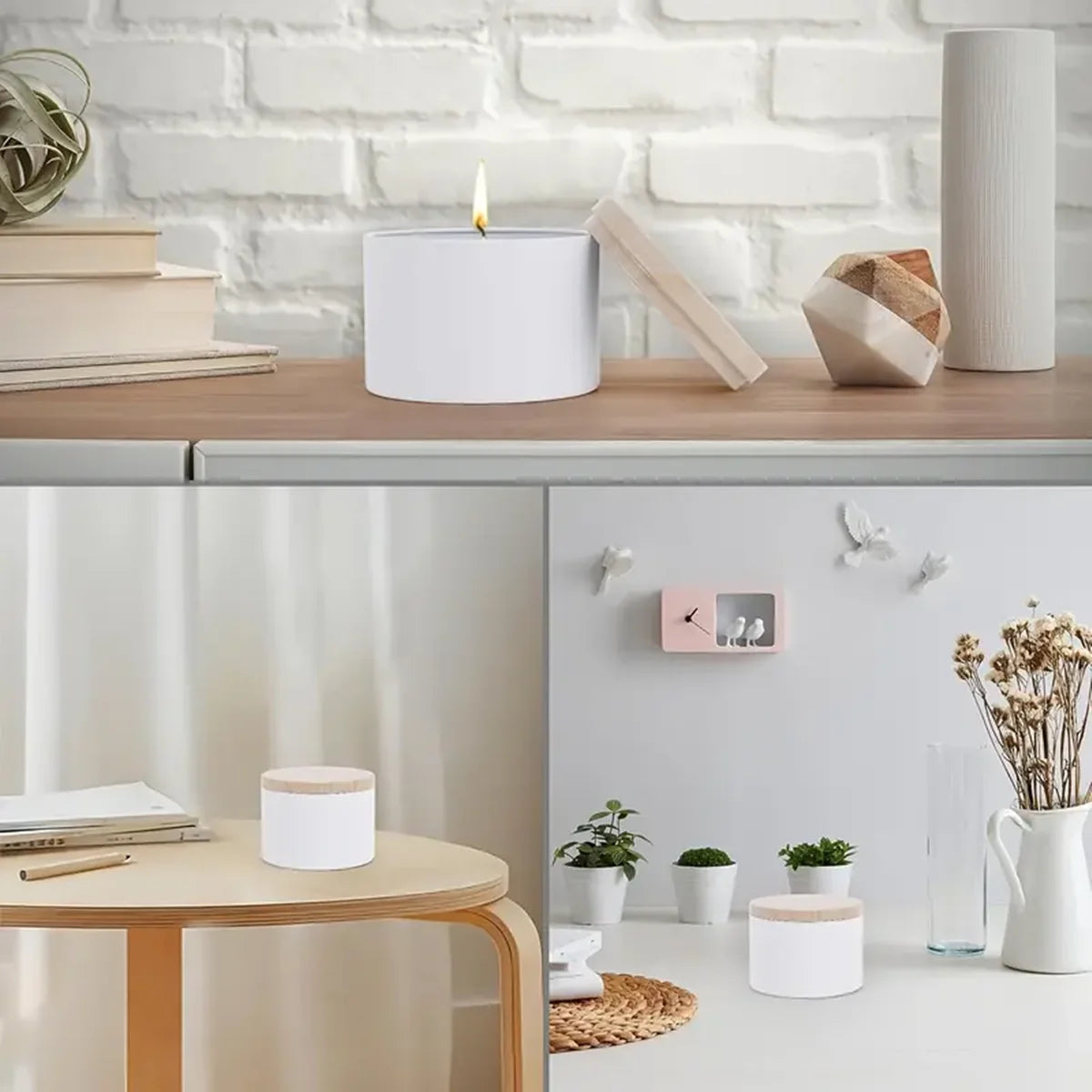 A set of white metal candle tins with lids displayed on a wooden table next to a white brick wall.