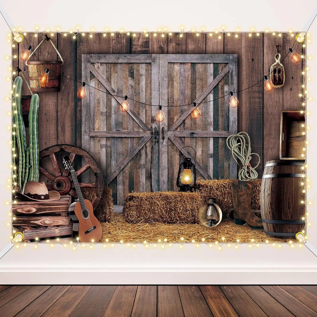 A rustic western backdrop featuring a wooden barn door, hay bales, and decorative string lights.