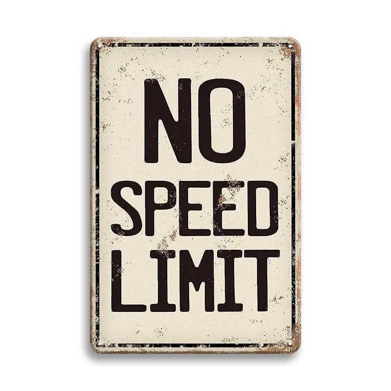 A vintage metal tin sign with distressed beige background and black text that reads NO SPEED LIMIT.