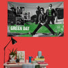 A decorative banner featuring a black and white photo collage of Green Day members against a green background.