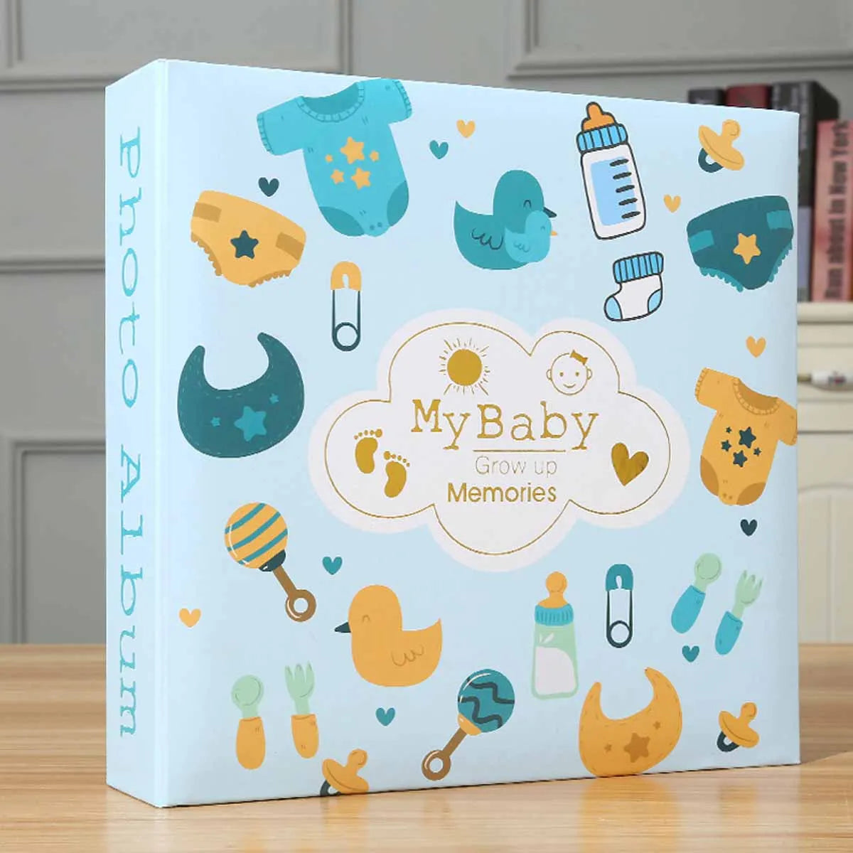 A light blue photo album cover featuring cute baby-themed illustrations like ducks, stars, and a cloud with the text My Baby 