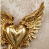 Gold ornate winged heart wall decor featuring detailed feather texture