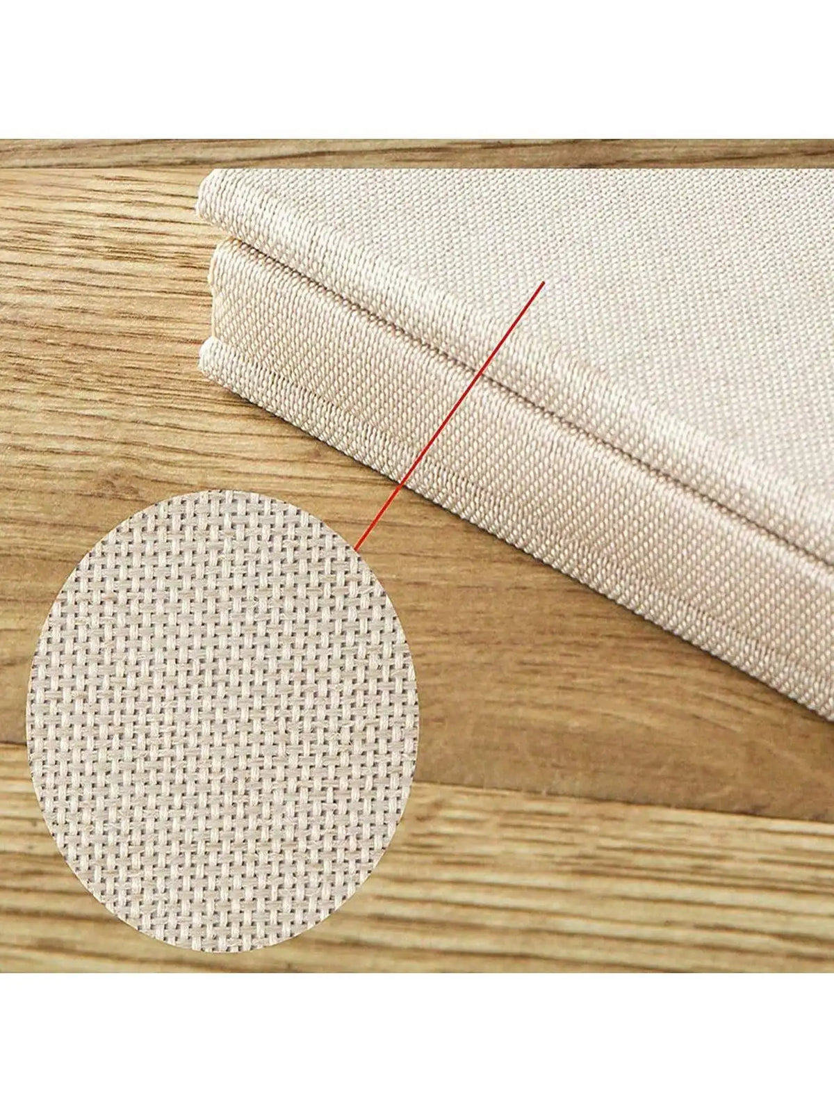 A close-up view of a linen scrapbook photo album with self-adhesive pages resting on a wooden surface.