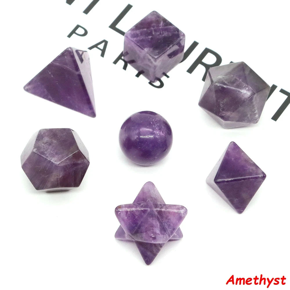 A set of seven amethyst crystals cut in various platonic geometric shapes and angles.