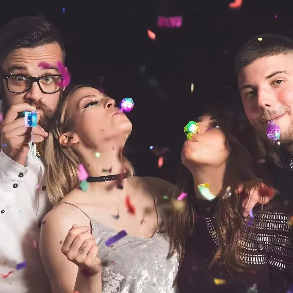 Group of four people looking up and blowing on glow in the dark necklaces and lanyards