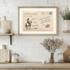 A framed vintage postcard print depicting a cowboy riding a horse in a western style.