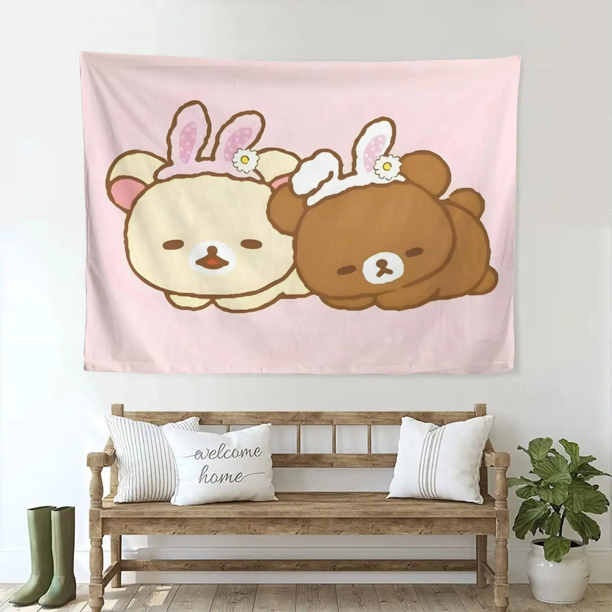 A pink tapestry featuring two cute cartoon bears, one light yellow and one brown, hanging on a wooden bench.