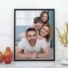 A family of four smiling in a custom photo canvas poster with a wood frame.