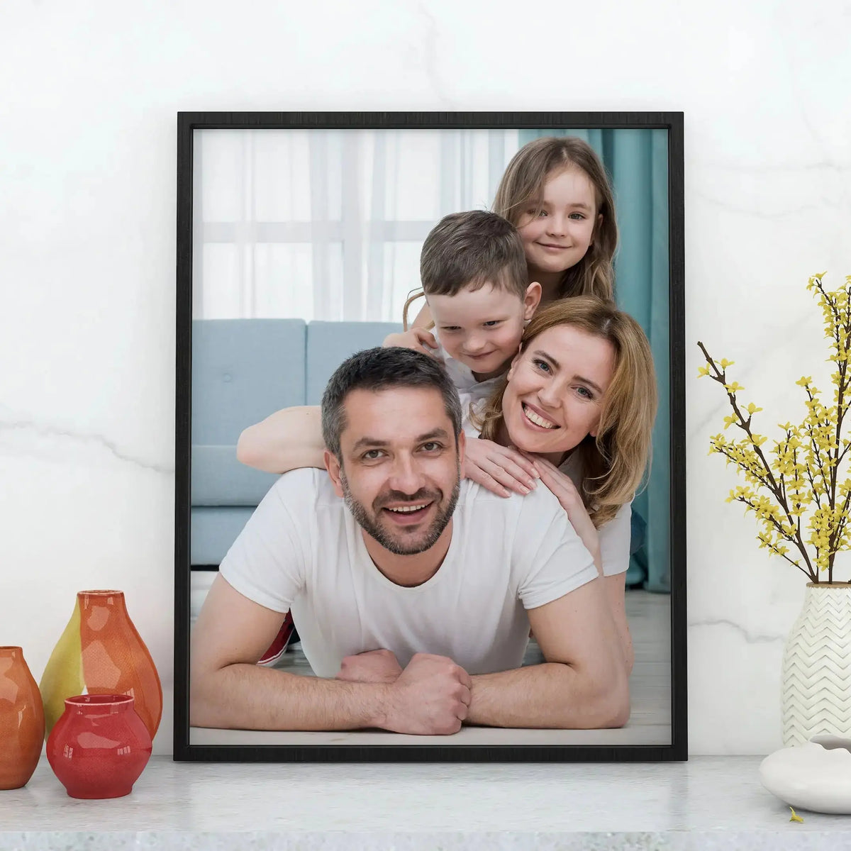 A family of four smiling in a custom photo canvas poster with a wood frame.