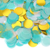 A close-up view of round tissue paper confetti dots in shades of teal and yellow.
