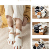 A set of plush socks featuring cat paw prints in beige, white, and brown tones.