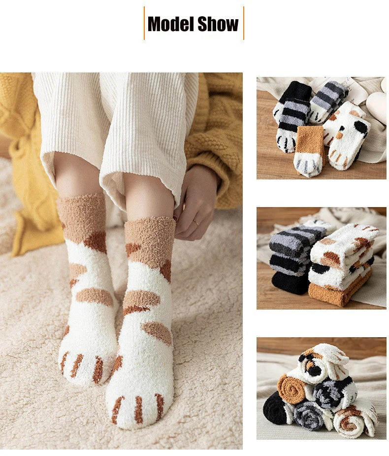 A set of plush socks featuring cat paw prints in beige, white, and brown tones.