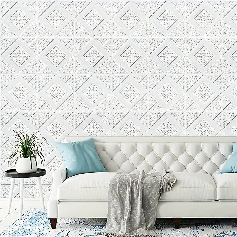 A white upholstered sofa with a light blue throw blanket and a patterned white wall panel background.