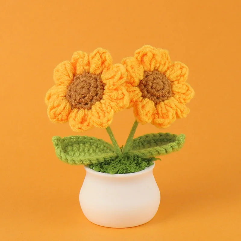 Hand woven crochet orange flowers in a white pot on an orange background