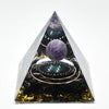 Handmade resin orgonite pyramid featuring natural obsidian and a copper coil.