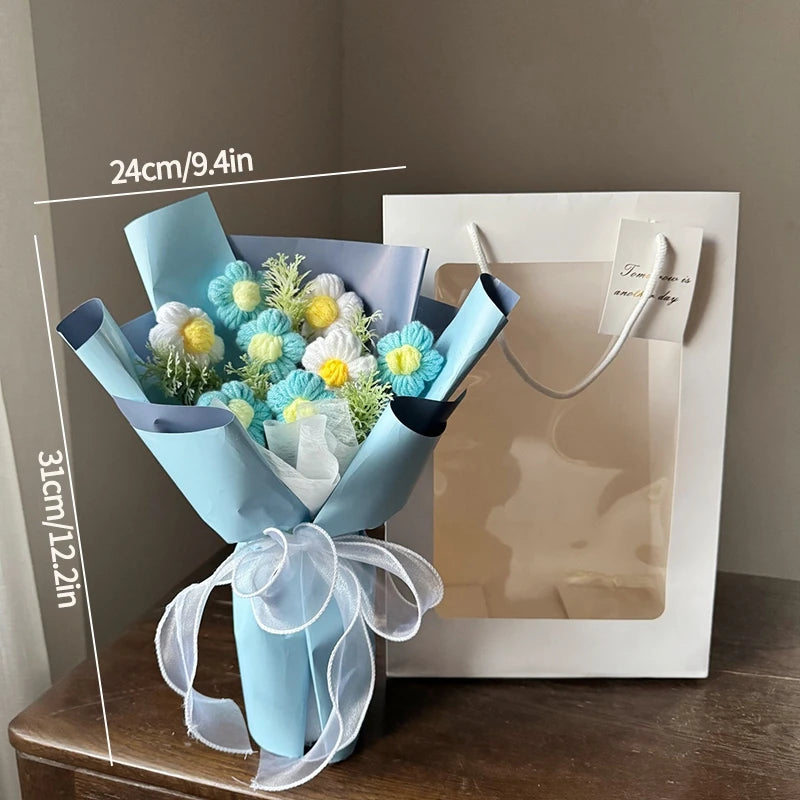 A light blue handmade crochet flower bouquet with white and yellow flowers is presented in a white gift box.