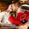 A couple shares a tender moment while a red rose is presented in an open gift box.