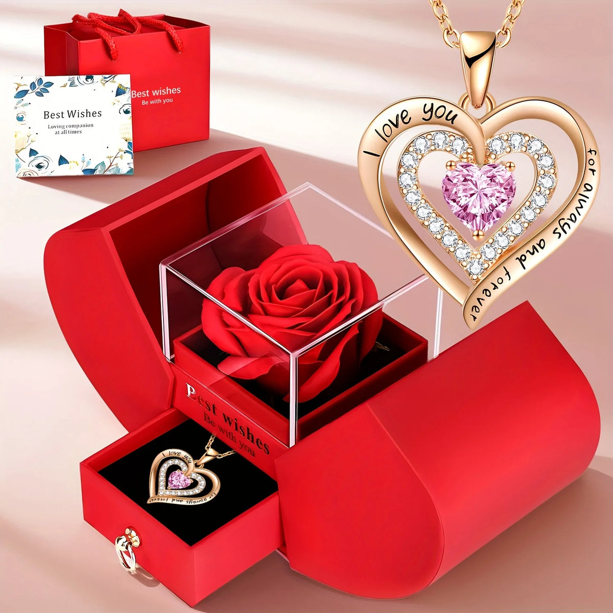 A gold heart pendant necklace is displayed alongside a red gift box containing a red rose and a small pendant.