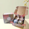 A gift set of soy wax aromatherapy candles in various scents including Lemon, Tea, Vanilla, and Jasmine packaged in cardboard