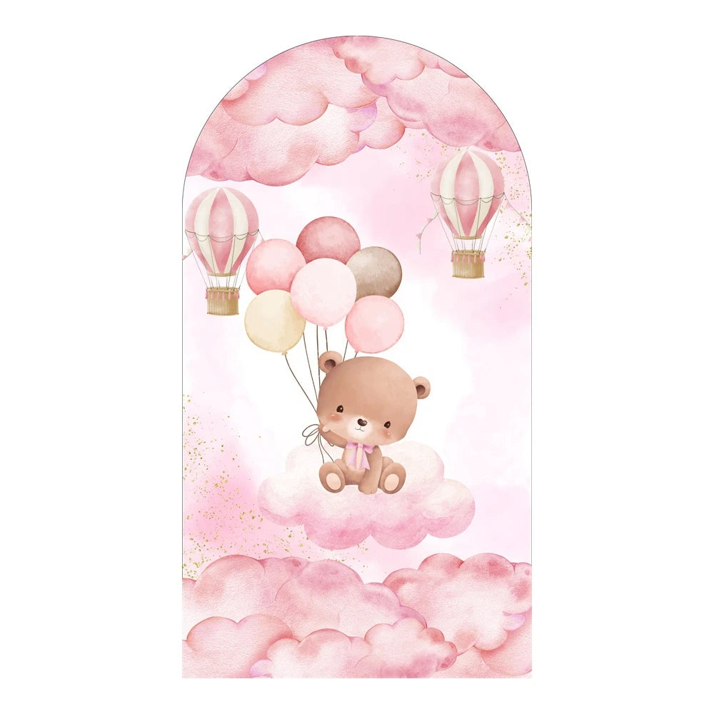 A watercolor illustration featuring a cute teddy bear floating among pink clouds and decorated with hot air balloons.