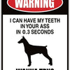 A warning sign featuring text and a silhouette of a dog.