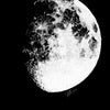 A minimalist black and white print of the moon phase showing craters and texture.