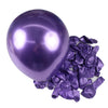 A single purple latex balloon is shown next to a pile of crumpled purple latex balloons for party decor.