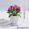 A potted artificial bonsai tree decoration with vibrant purple and white flowers on a white background.
