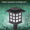 A black, square-shaped outdoor pathway light fixture with a grid of white lights is shown in the rain.