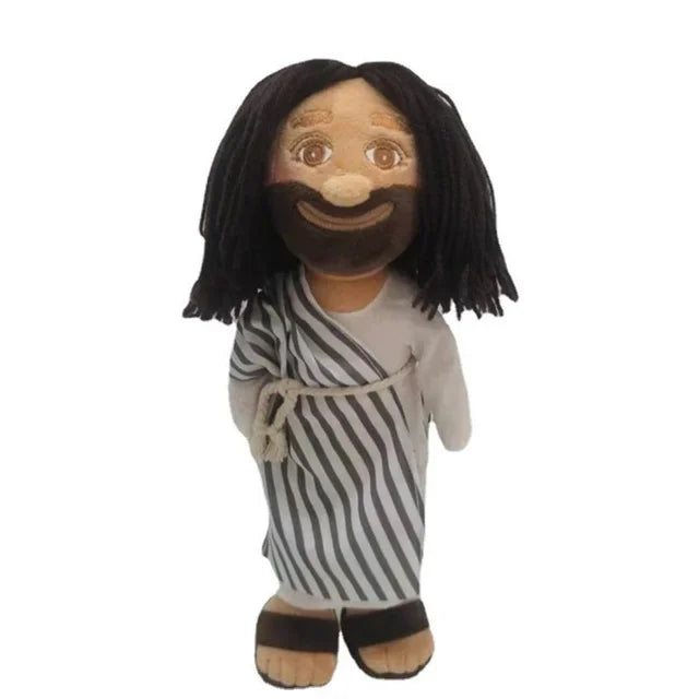 A plush doll depicting Jesus and Mary with dark hair and a striped shirt.
