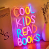 A neon sign spelling out COOL KIDS READ BOOKS illuminated on a wall.