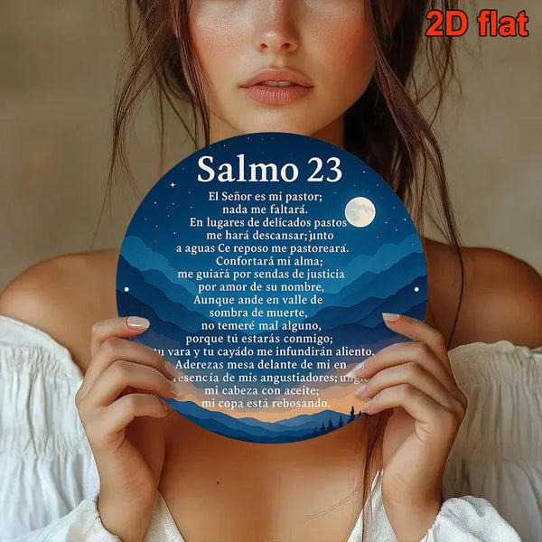 A woman holds a circular piece of art featuring Psalm 23 text on a dark blue background