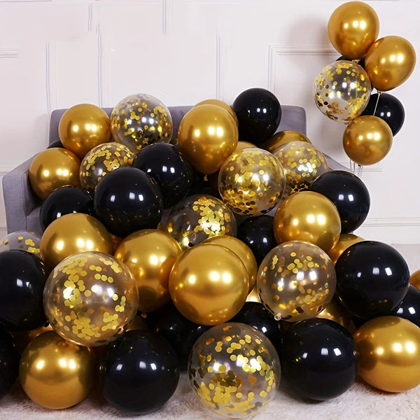A collection of black and gold confetti balloons arranged on a white surface.