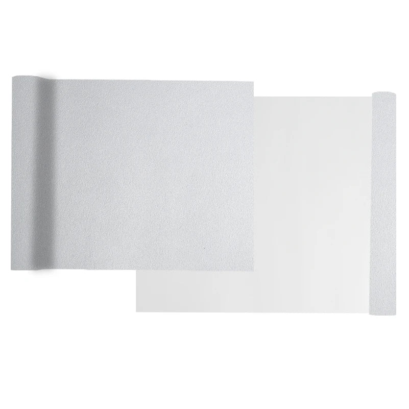 A sheet of white self-adhesive suede wrap fabric shown with a rolled edge.