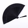 A black traditional Chinese folding fan with pleated ribs, shown open and angled.