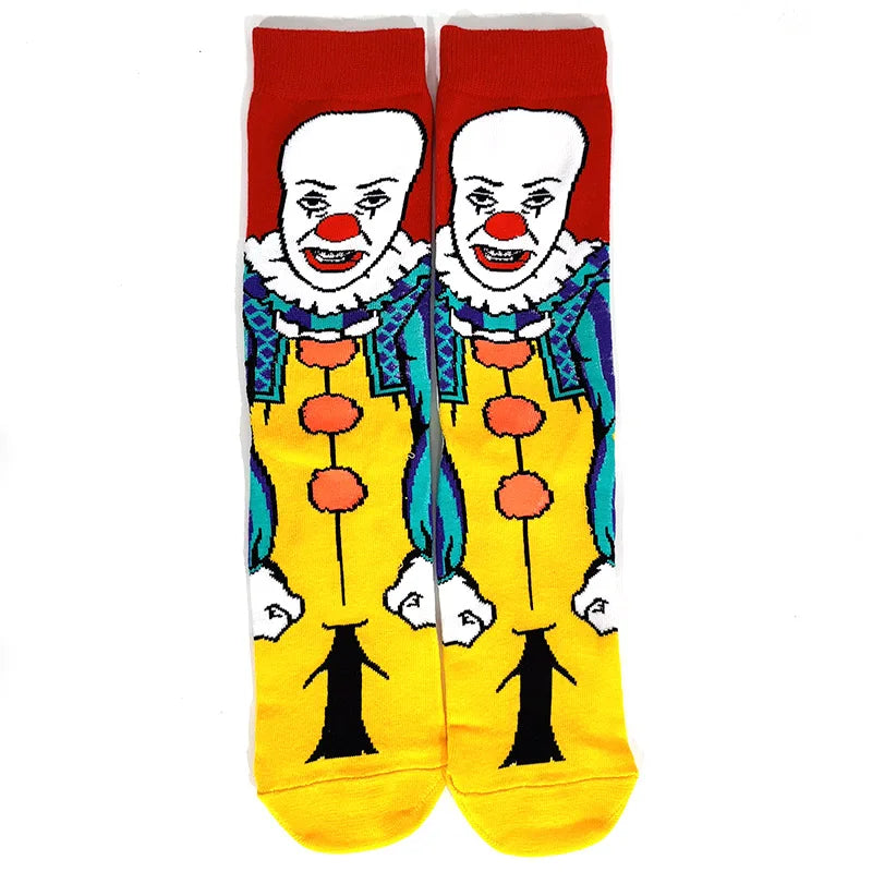 A pair of novelty crew socks featuring skull, alien, and tiger prints on a yellow background.