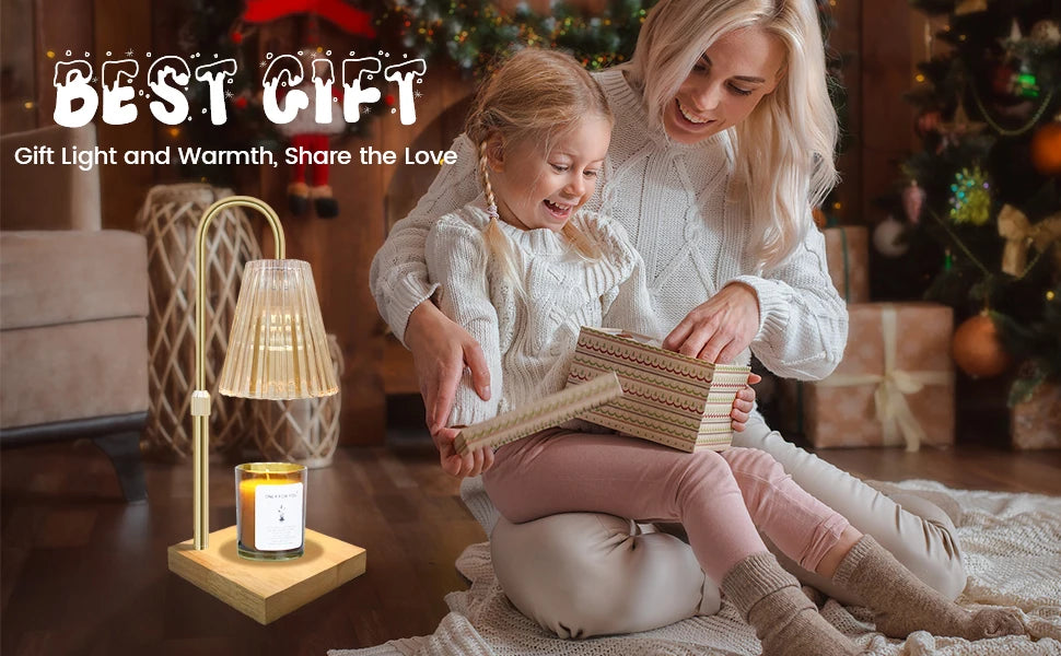 A woman is holding a child while using an elegant gold candle warmer lamp with a timer and adjustable height.