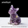 A small, translucent purple crystal dog statue used as a dropper for Feng Shui and decor.