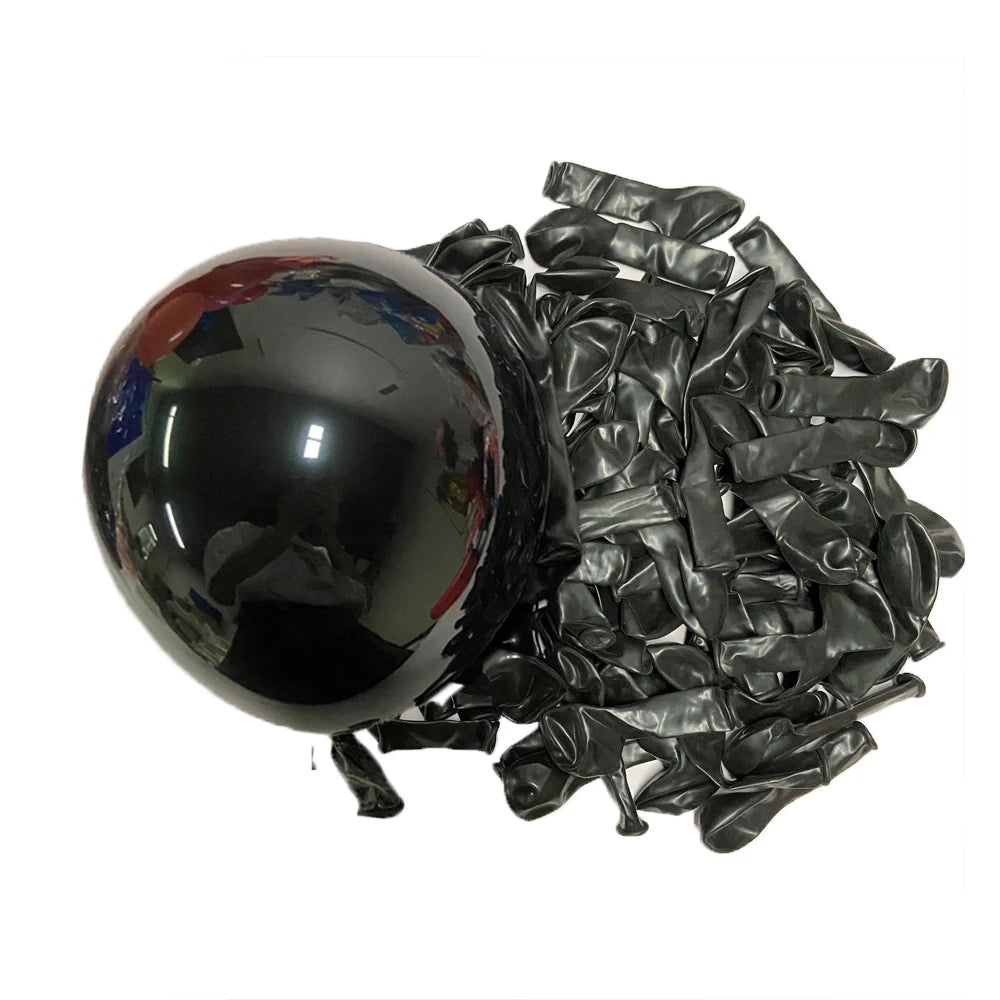 A black latex balloon is shown next to a pile of black latex balloons.