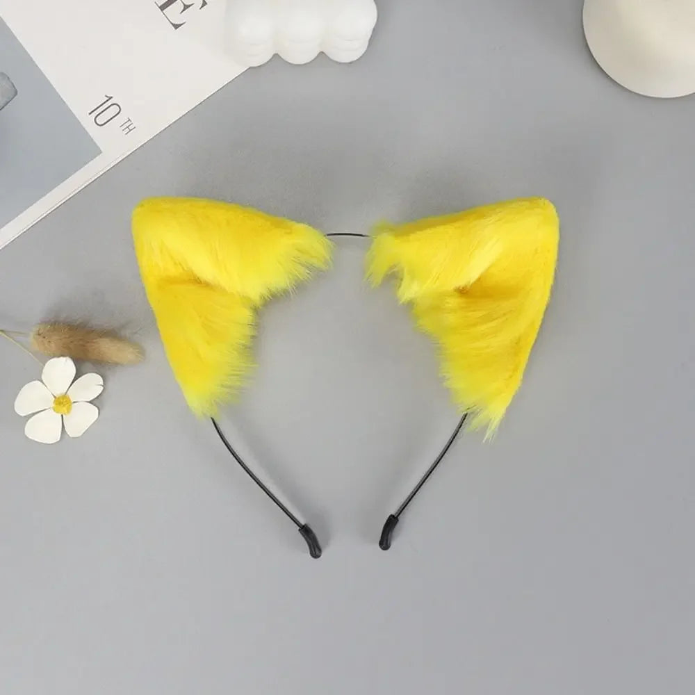 Yellow plush fox ears headband with black straps and a white flower nearby