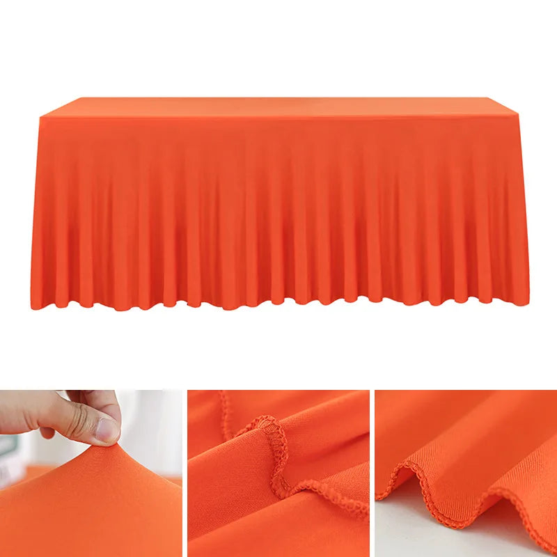 Orange stretch rectangle tablecloth draped on a table, showing its pleated texture.