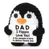 A black and white penguin plush toy with an orange beak, featuring a tag that reads Dad I Flippin Love You!