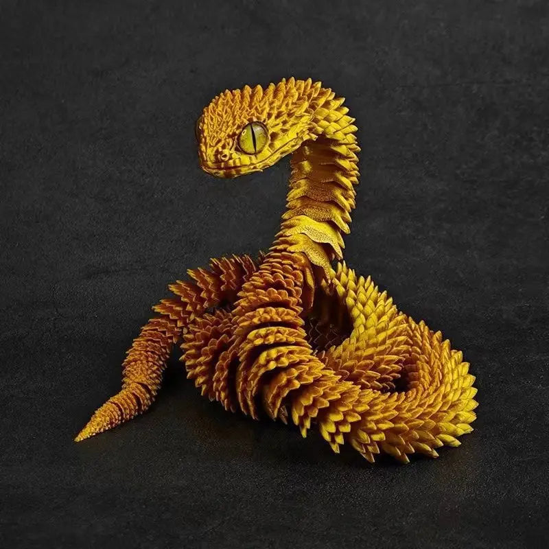 A golden, textured snake art model is coiled on a dark surface.
