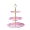 A three-tier pink plastic cupcake stand with a gold-colored mirror topper.